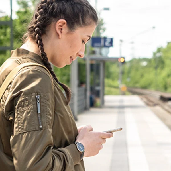 A young girl looks at her mobile phone
