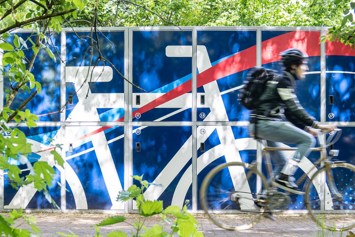 Fahrradfahrer fährt an den Fahrradboxen von Mein Radschloss vorbei