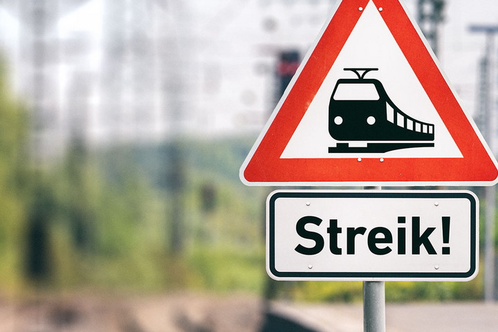 Streik Hinweisschild, im Hintergrund ein Bahnsteig und Gleise