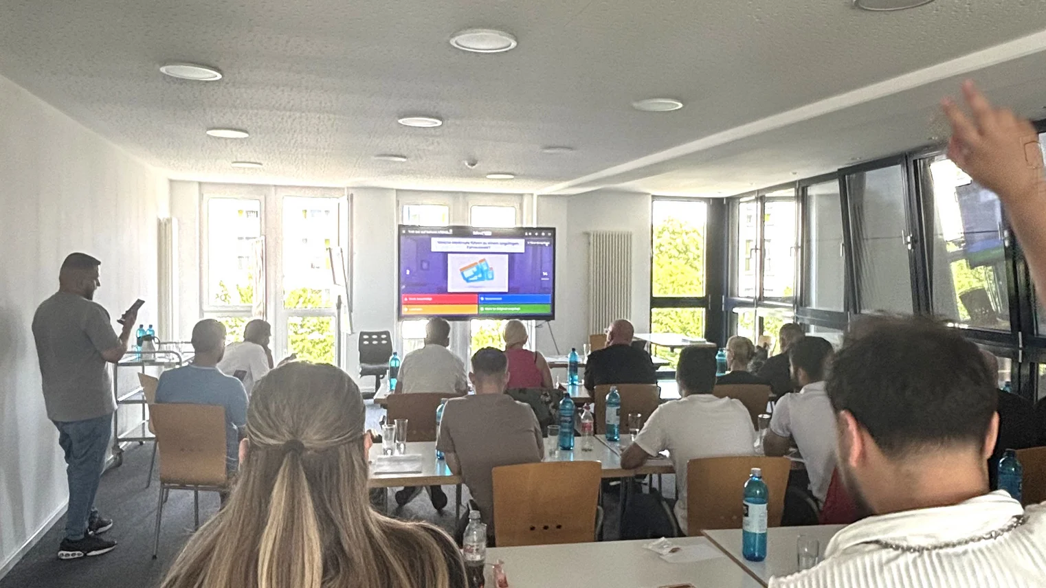 Eine Gruppe von Schülern sitzt vor einer Tafel.