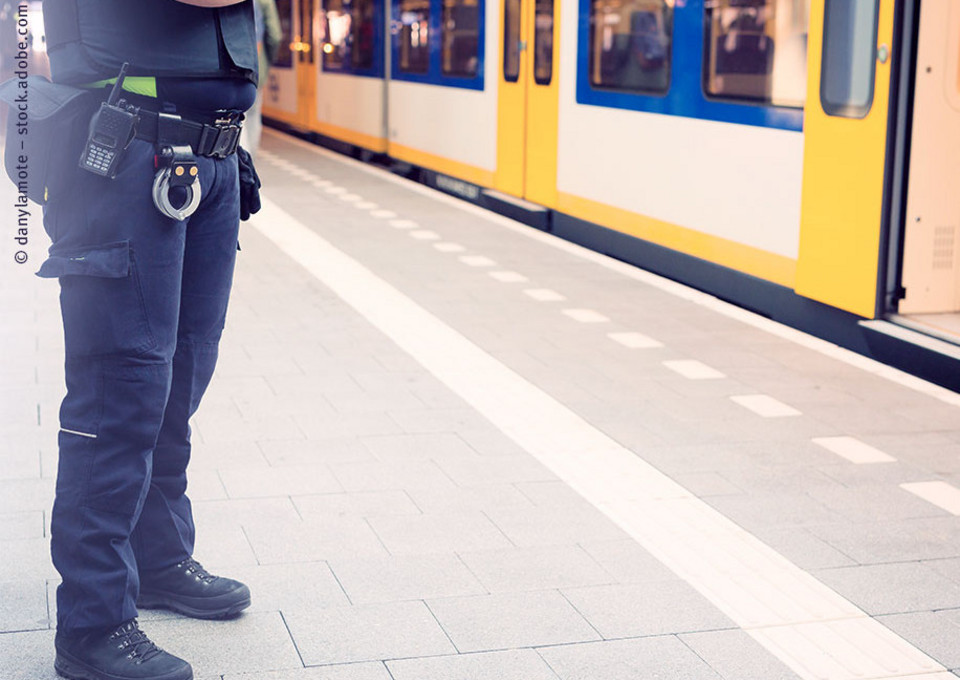 Ein Sicherheitsmitarbeiter im Einsatz am Bahnsteig einer Station.