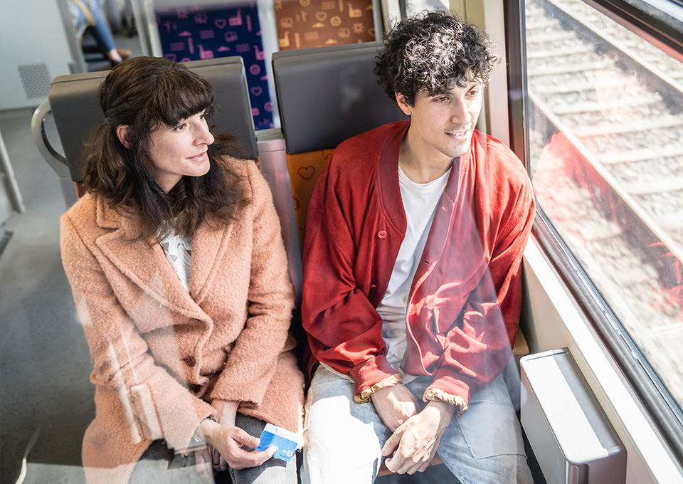 Eine Frau und ein Mann sitzen gemeinsam im Zug