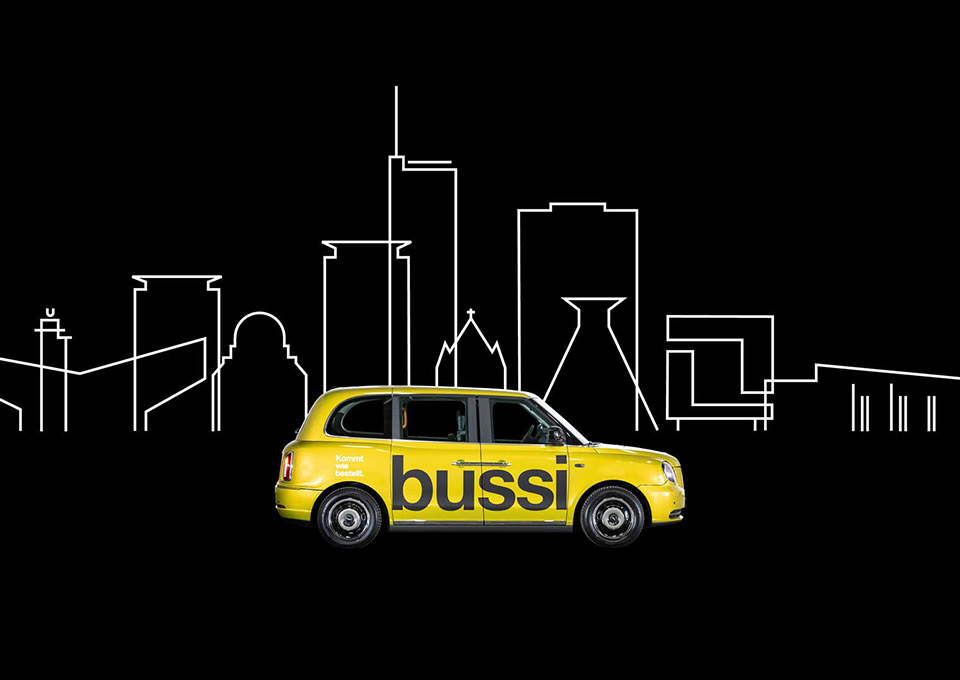 Gelbes Bussi-Fahrzeug vor einer stilisierten Skyline von Essen auf schwarzem Hintergrund